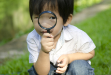 Little boy holding a magnifying glass